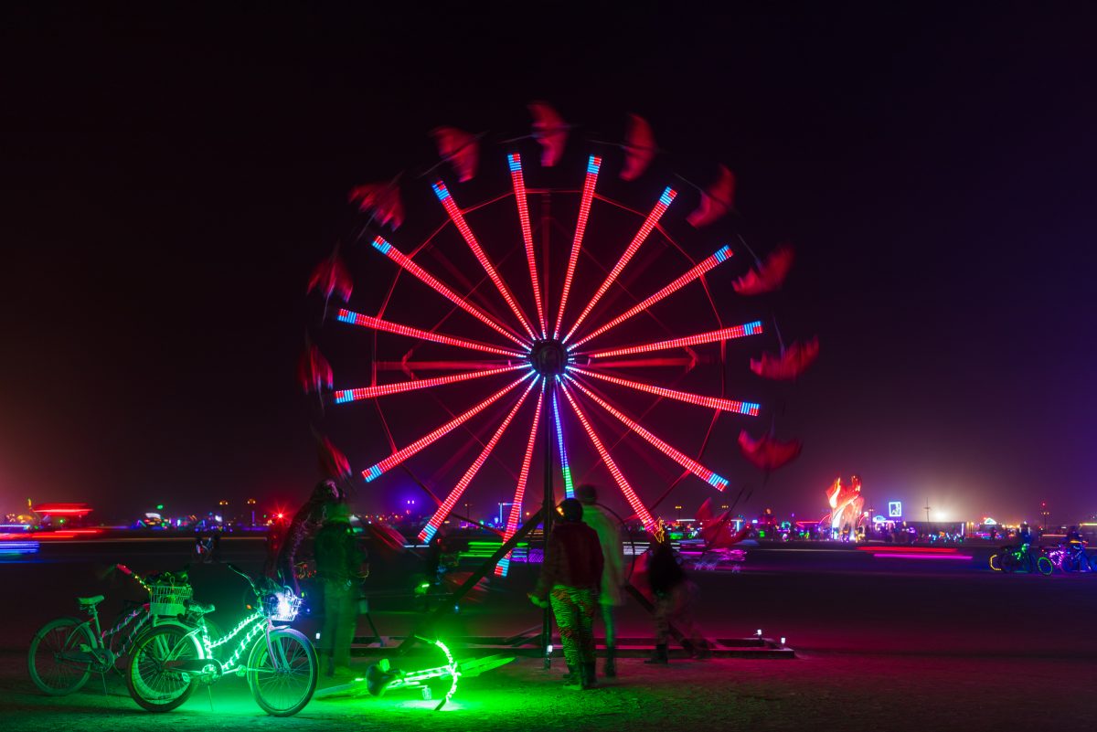 Parasolvent from: Anaheim, CA year: 2016  "Parasolvent" is an interactive kinetic sculpture. A 23 foot tall rotating ring of parasols that open as they ascend and close as they fall. Parasols are protective devices created to shield us from the elements. Here they represent the emotiona...