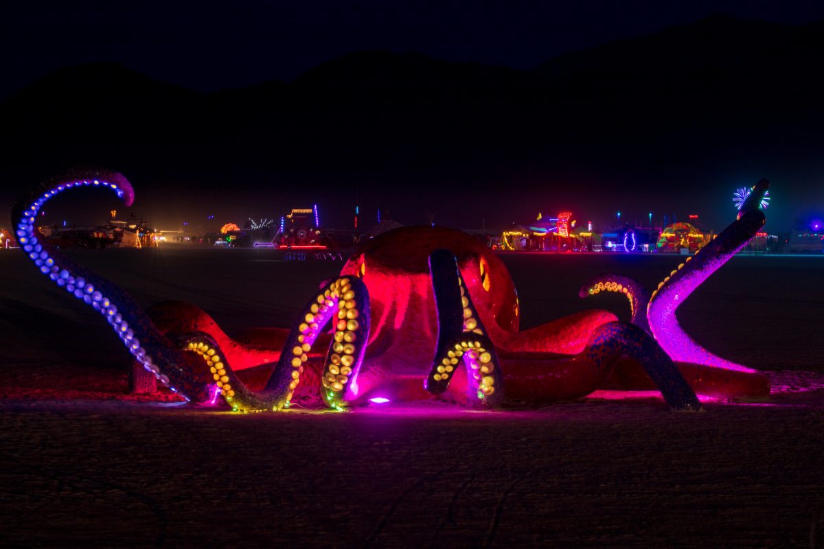 Octavius from: Verdi, NV year: 2016  Octavius is a giant octopus covered in a bright mosaic of hand-cut ceramic tiles in shades of orange, blue, and purple. The eyes and suckers are molded glass, and glow with the light of hundreds of LED bulbs, symbolizing enlightenment from within. Representati...