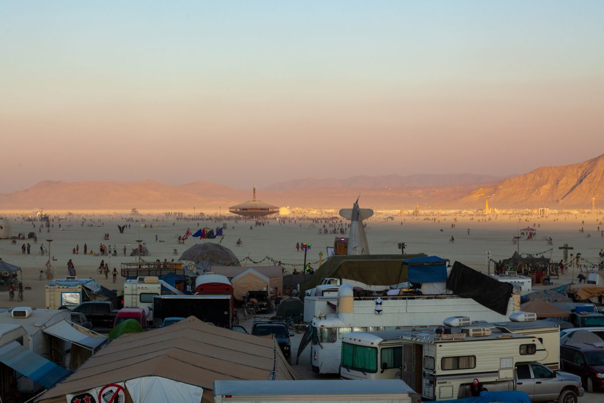 The shadow of surrounding hills crosses the playa as the sun sets.