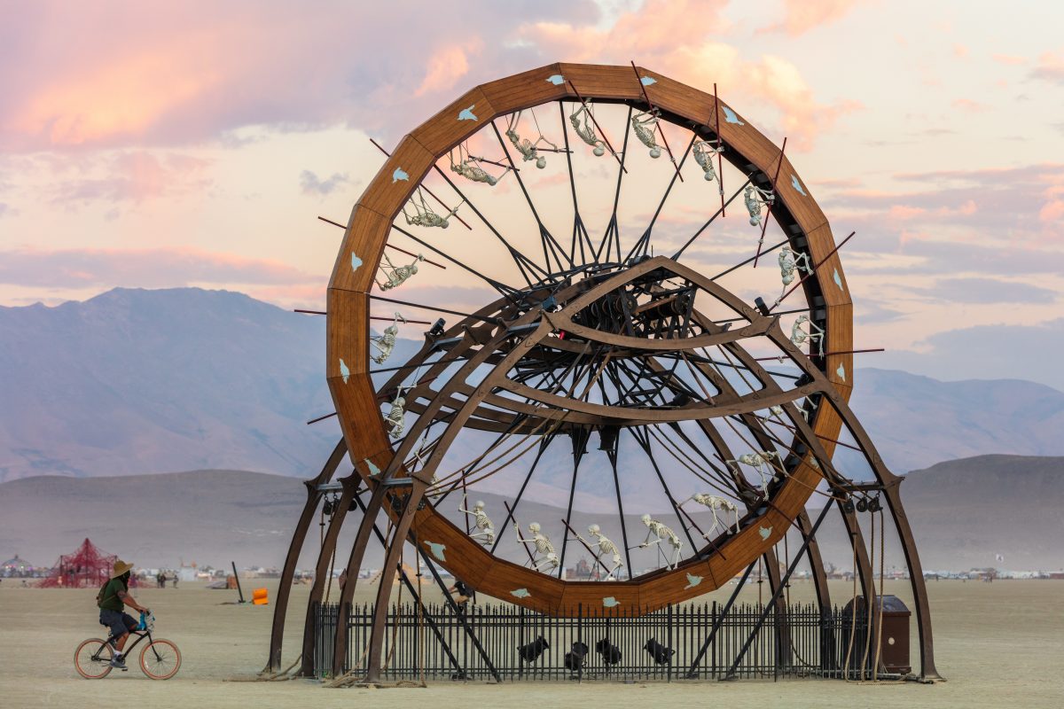 Charon by: Peter Hudson from: San Francisco, CA year: 2017  A gigantic 30′ spinning wheel with posed human skeletons mounted on its inner edge, Charon is fully powered by a minimum of 12 people working in unison. Participants are invited to pull a series of 6 ropes which cause the wheel to rotate...
