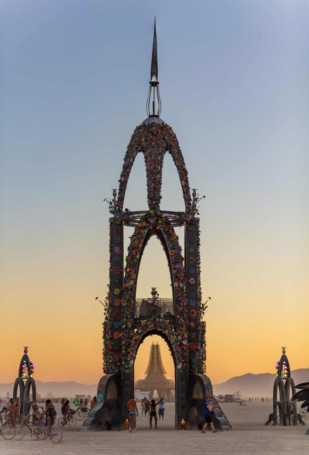 The Flower Tower by: Kevin Clark, Reared In Steel from: Petaluma, CA year: 2017  The Flower Tower is a 70 foot tall metal structure ornately decorated by thousands of painted metal flowers, some of which will blow fire. Contact: flowertower@rearedinsteel.com
