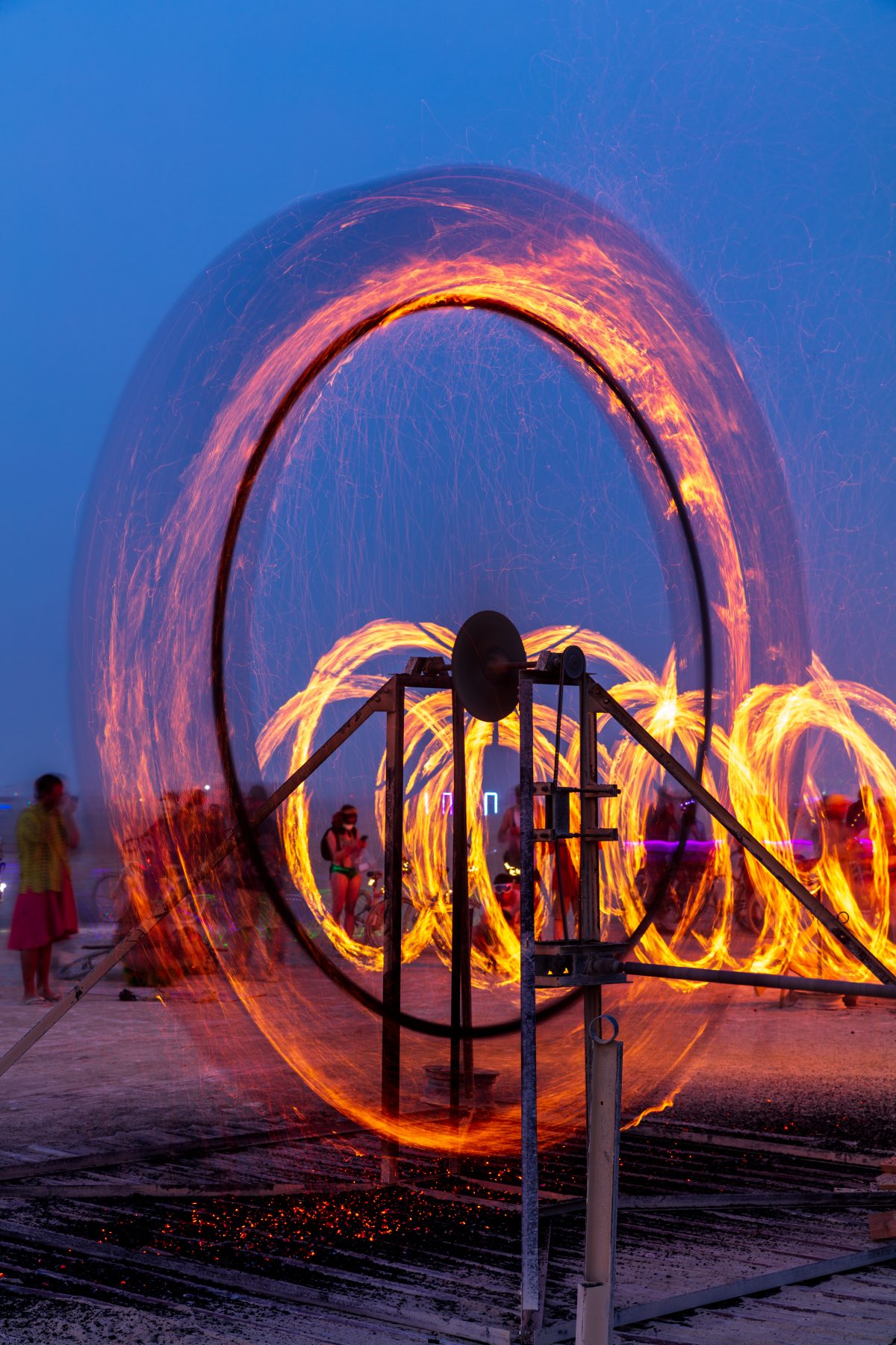 Fire Spinner by: Anton Viditz-Ward from: Telluride, CO year: 2017  Fire Spinner is a steel mechanical wheel 13′ tall, it has 2 steel baskets that hold wood. Those baskets are set on fire, the wheel is then set in motion via a 20′ long drive shaft and a hand crank mechanism. Fire Spinner is inspir...