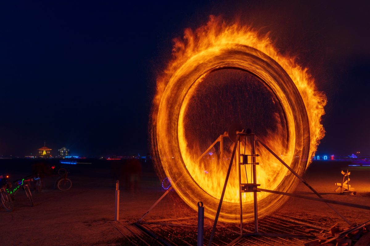Fire Spinner by: Anton Viditz-Ward from: Telluride, CO year: 2017  Fire Spinner is a steel mechanical wheel 13′ tall, it has 2 steel baskets that hold wood. Those baskets are set on fire, the wheel is then set in motion via a 20′ long drive shaft and a hand crank mechanism. Fire Spinner is inspir...