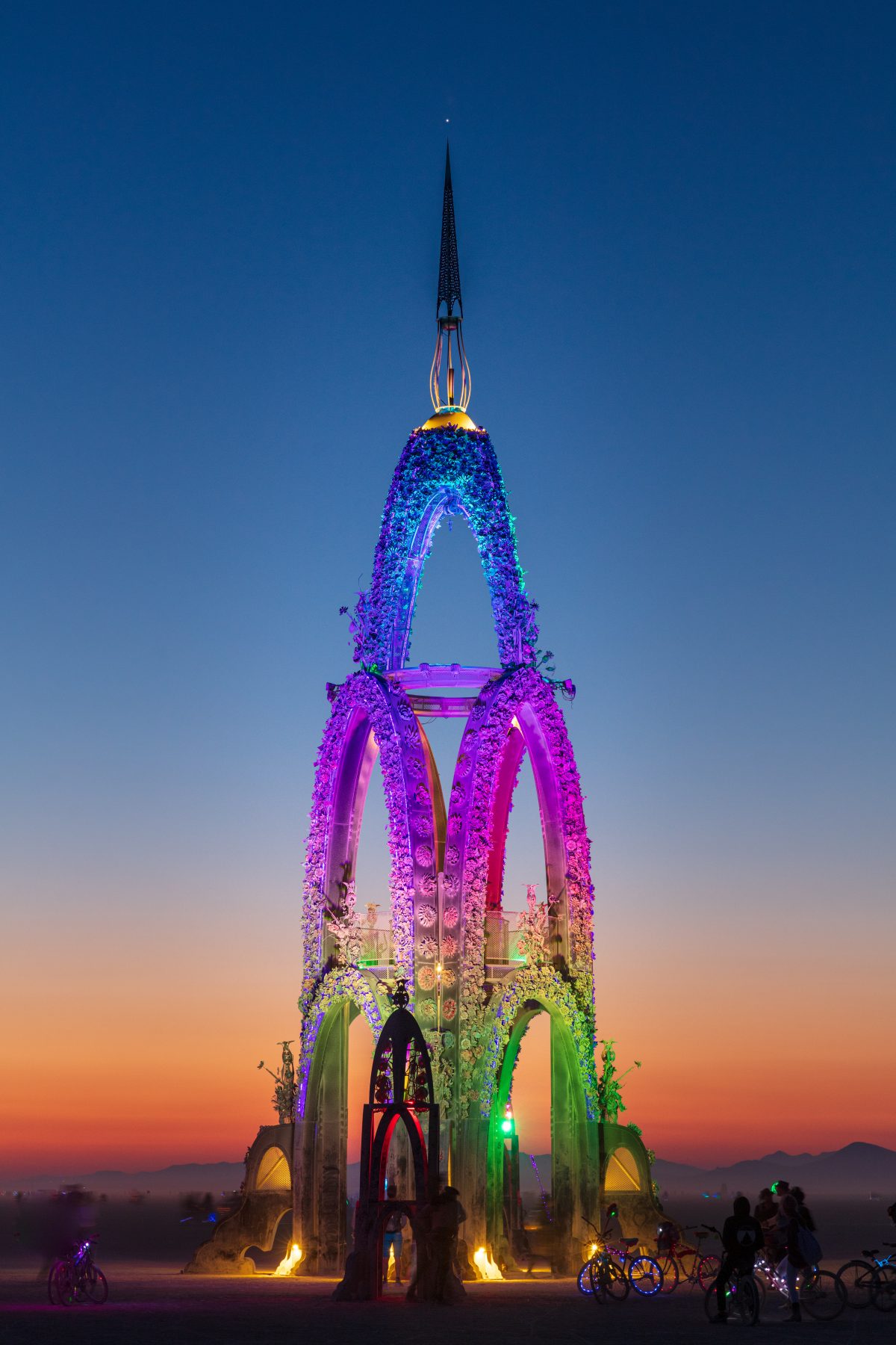 The Flower Tower by: Kevin Clark, Reared In Steel from: Petaluma, CA year: 2017  The Flower Tower is a 70 foot tall metal structure ornately decorated by thousands of painted metal flowers, some of which will blow fire. Contact: flowertower@rearedinsteel.com