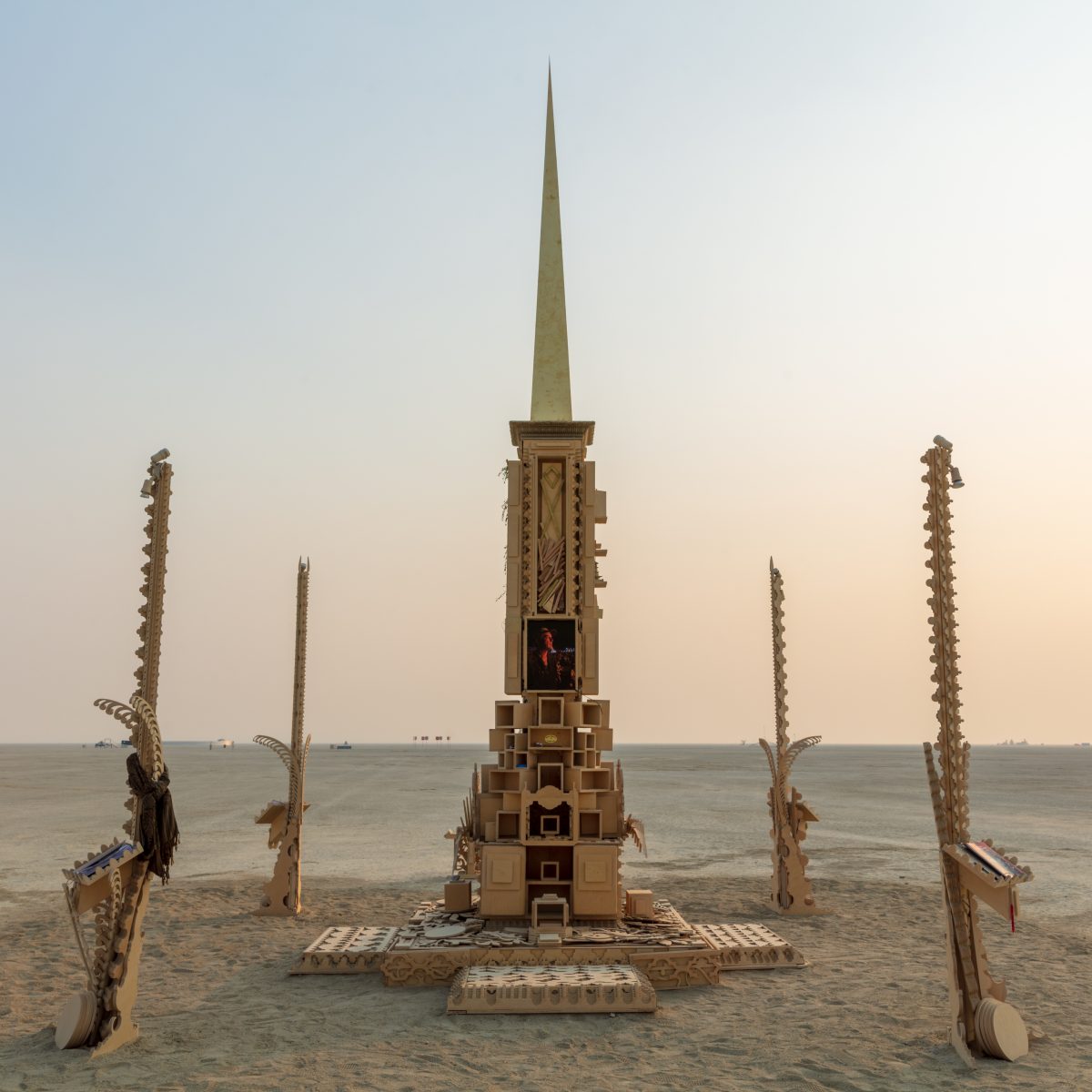 The Larry Memorial by: Dana Albany, Andrew Johnstone, David Best, Flash Hopkins from: San Francisco, CA year: 2019  A stepped pyramid crowned with a palanquin and large spire, flanked on each corner by lamplighter spires. It serves as a physical representation of Larry's mind palace and contains ...