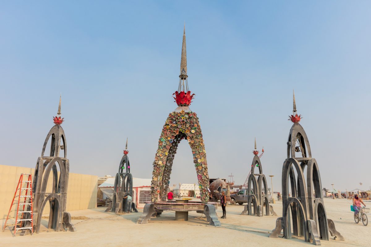 The Top of Flower Tower by: Kevin Clark, Reared In Steel from: Petaluma, CA  The Flower Tower is a 70 foot tall metal structure ornately decorated by thousands of painted metal flowers, some of which will blow fire. Contact: flowertower@rearedinsteel.com