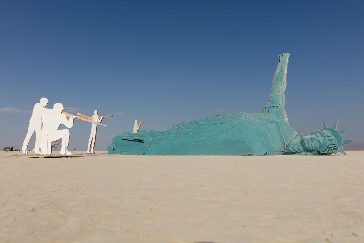 Freedom Killed Lady Liberty by: Sy Van Tran and Houston Burners from: Houston, TX year: 2018  The large scale installation of the Statue of Liberty gunned down and holding up her heart asks Participants to ponder the meaning of Freedom Killed Lady Liberty. Seeing the icon of lady liberty illustra...