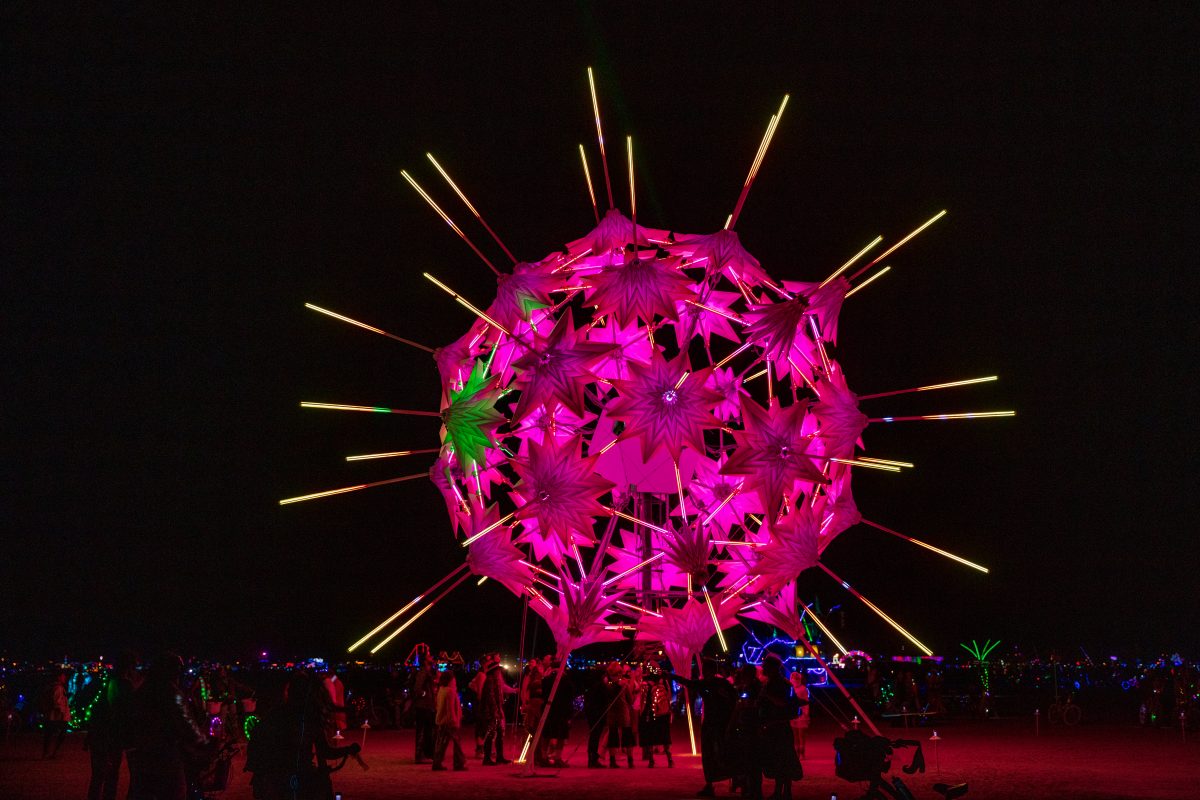 RadiaLumia by: FoldHaus Collective from: Oakland, CA year: 2018  RadiaLumia is a geodesic sphere, five-stories tall, and covered with a breathing skin of origami shells and radiant spikes. Its shape nods to radiolaria, a tiny protozoa with intricate mineral skeletons that covered the desert thous...