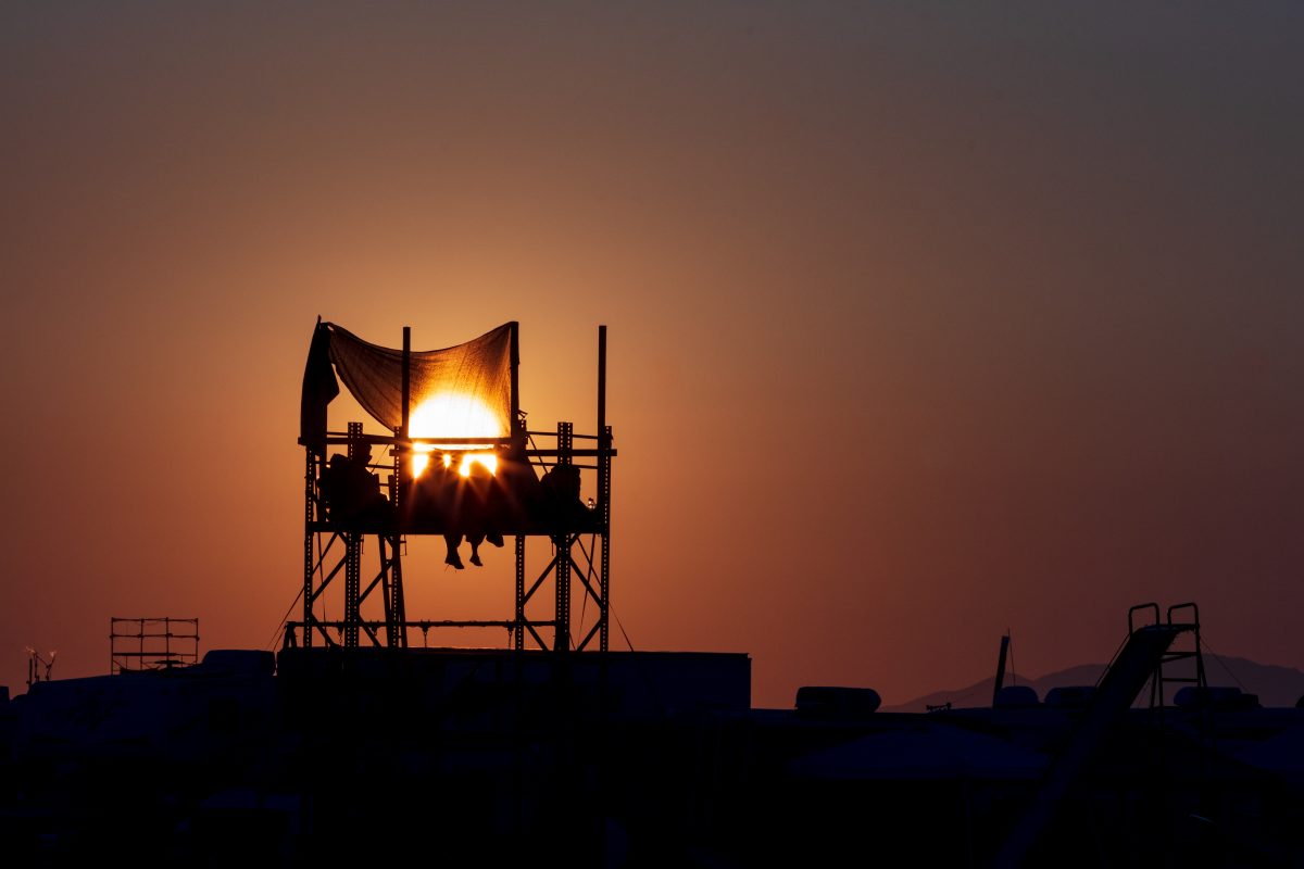 Burners enjoy sunrise atop platform.