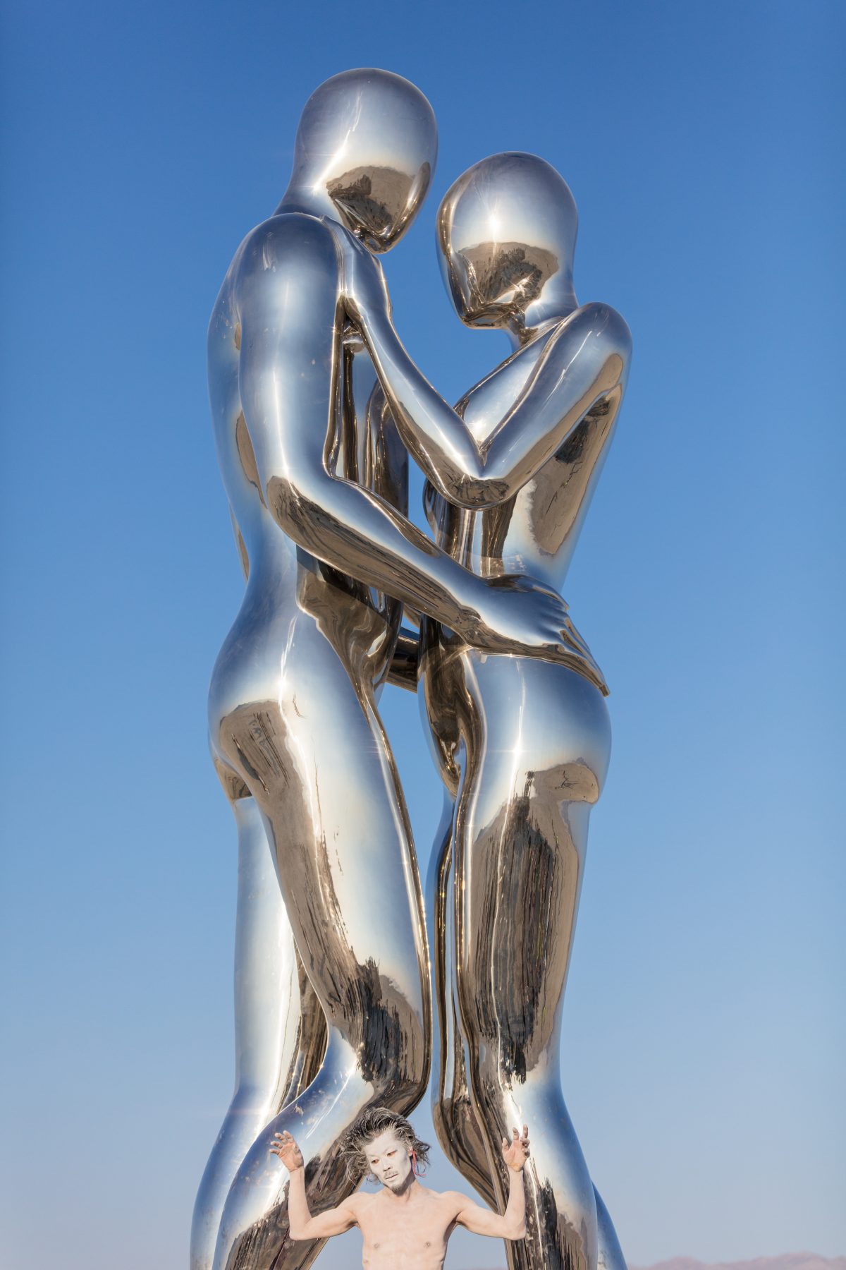 SENTIENT AI by: Michael Benisty, Love and Unity from: Brooklyn, NY year: 2018  A sculptural representation of Male and Female holding one another in a symbolic and universal position of caring in a display of Love and Unity. Measuring 25 feet tall and made out of mirror polished stainless steel. ...