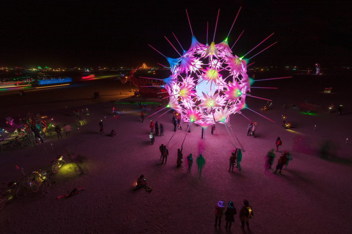 RadiaLumia by: FoldHaus Collective from: Oakland, CA year: 2018  RadiaLumia is a geodesic sphere, five-stories tall, and covered with a breathing skin of origami shells and radiant spikes. Its shape nods to radiolaria, a tiny protozoa with intricate mineral skeletons that covered the desert thous...