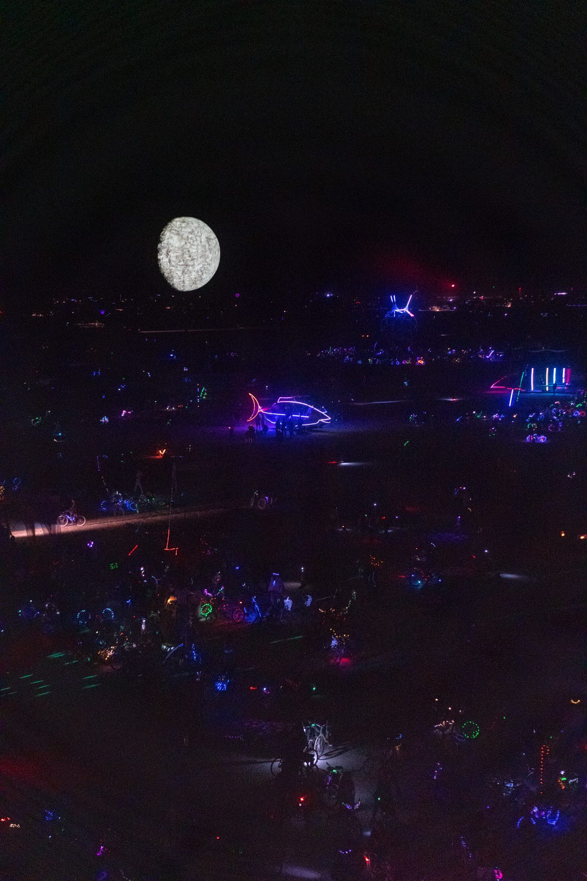 This Too Shall Pass - Moondancer by: Lekha Washington from: Mumbai, India year: 2018  High up in the night sky, a giant glowing sphere, half lit, half black, uneven surfaced, can be seen from far across the playa- except that it is a shape-shifting, dancing form that feels like a moving planet - ...