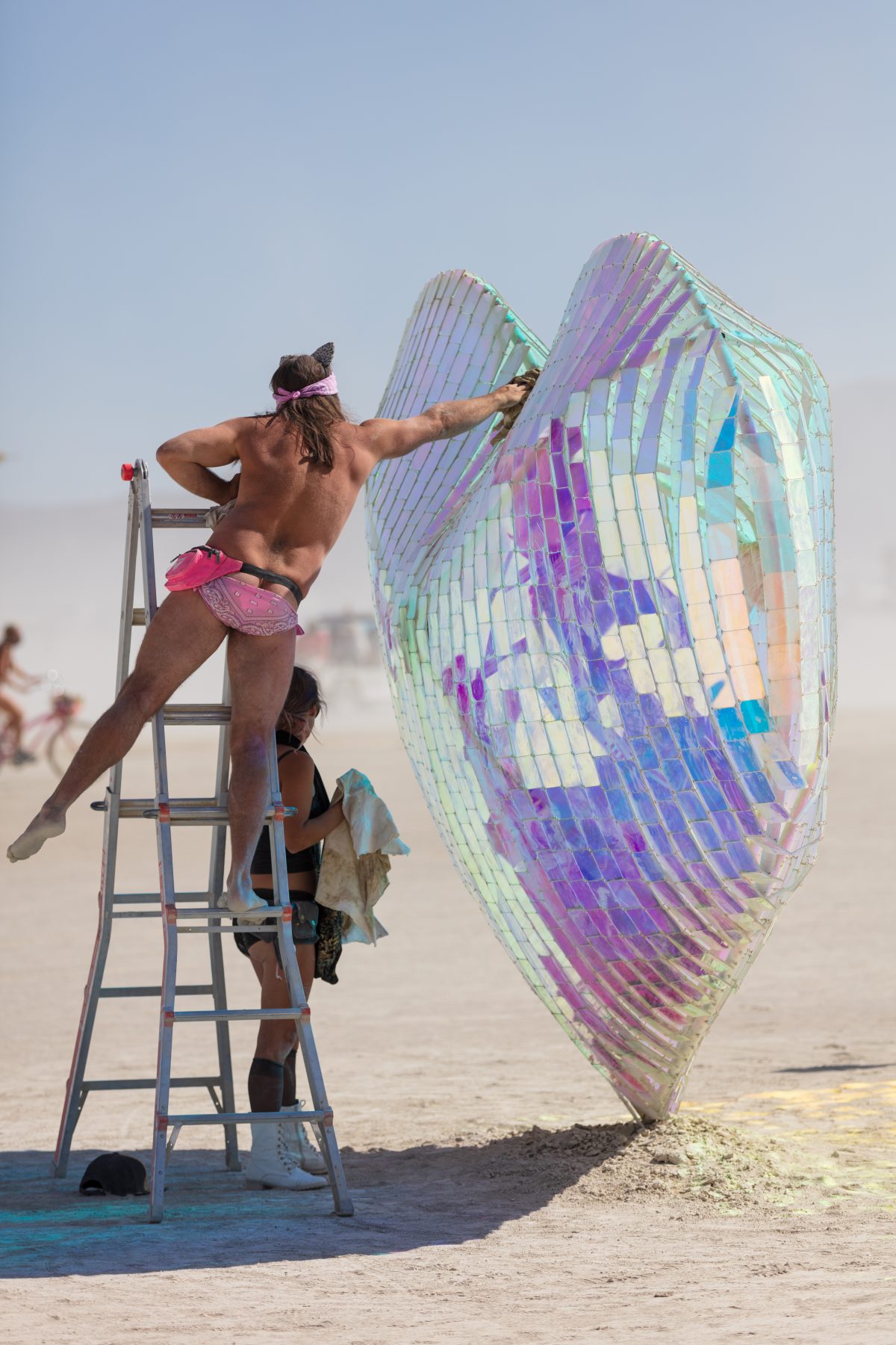 Koro Loko by: Emily Nicolosi from: Salt Lake City, UT year: 2019 A billowing heart made of wire netting filled with hundreds of tiny dichroic plexi squares refracts the spectra of light in all directions. Benches under lightposts encircling the heart provide a place to hunker, commune and daydrea...