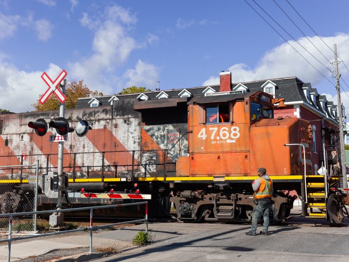 Engineer Guiding Locomotive Through Intersection