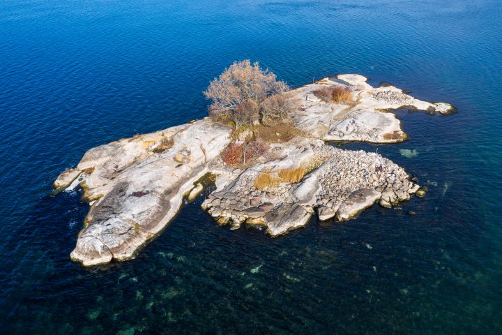 Small Island With Stones on Shore