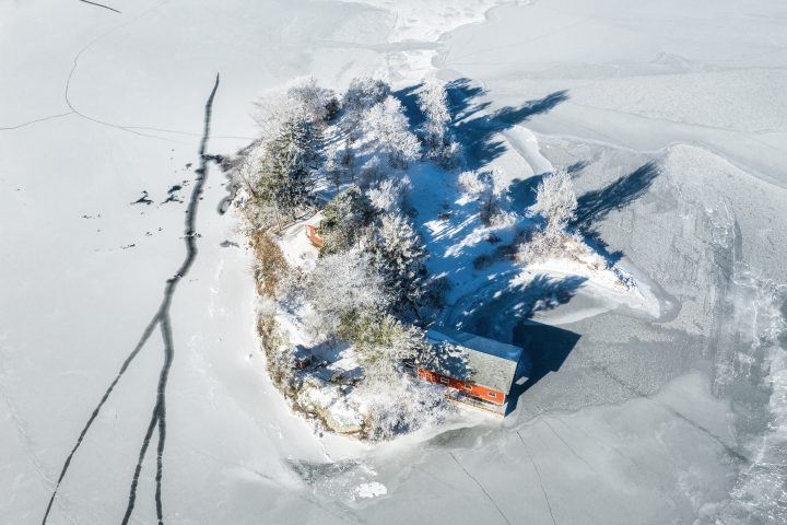 Small Island with Frosty Trees and Boathouse