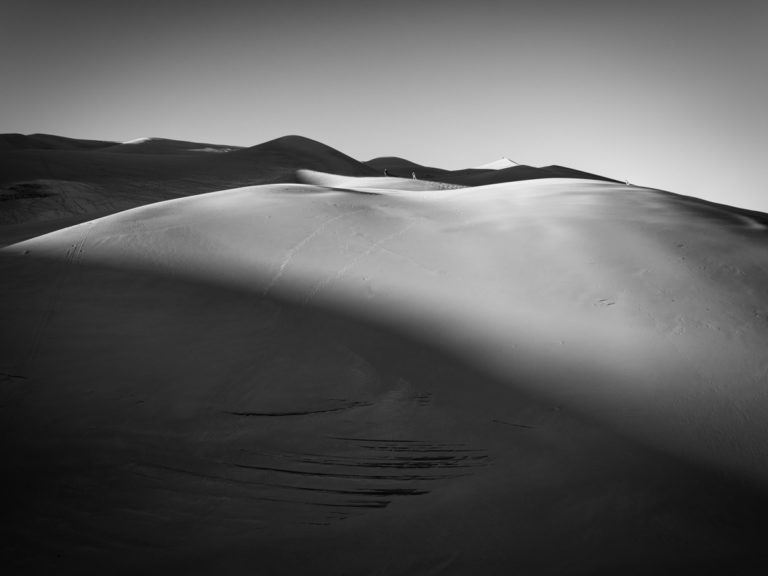 People Climbing on Dunes