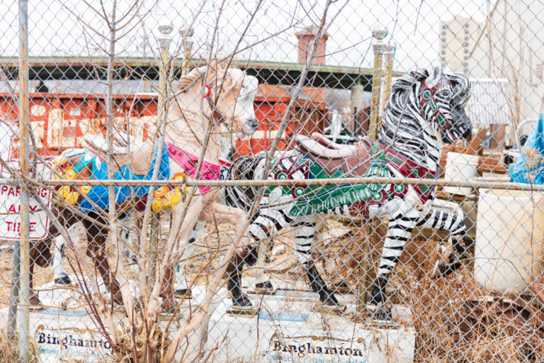 Merry Go Round Horses Behind Chain Link Fence