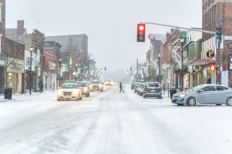 Person Crossing the Street in Small Town