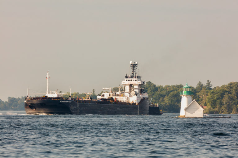 Ship Passing Small Lighthouse