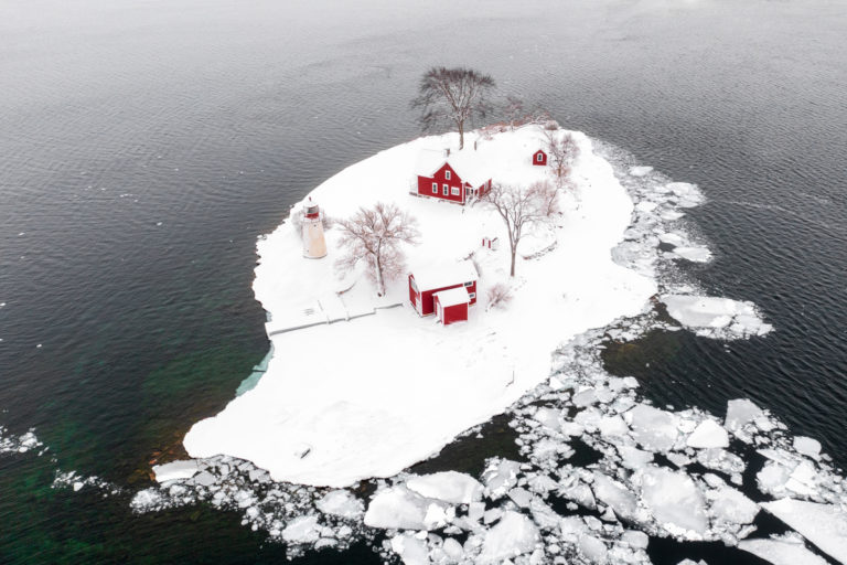 Small Island with Lighthouse and Red Buildings