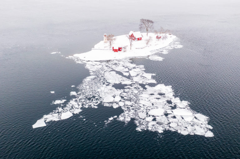 Ice Floe and Lighthouse on Small Island