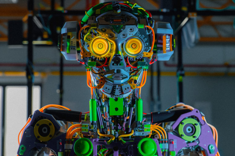 Yellow-Eyed Humanoid with Circuitry and Cables
