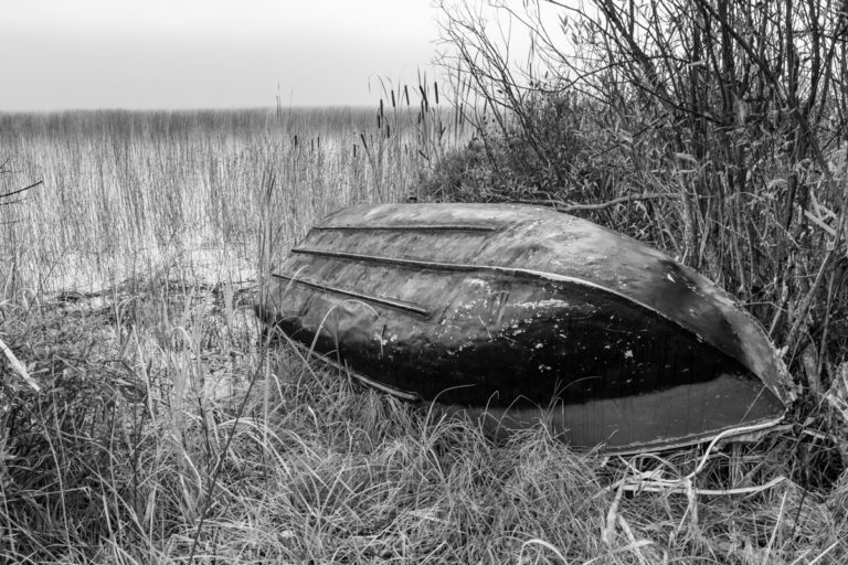 Mysterious Abandoned Boat on Lakeshore