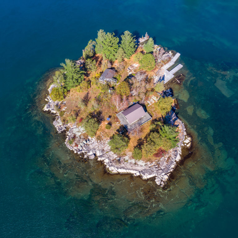 Remote Cabin on a Tiny Island in Clear Blue Water