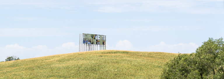 Weathered Billboard Overlooking Cornfield