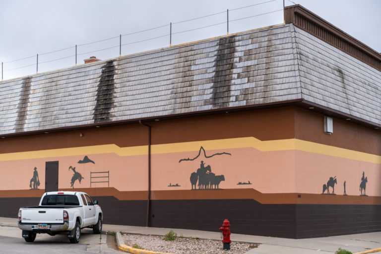 Western Silhouettes on Painted Building Wall