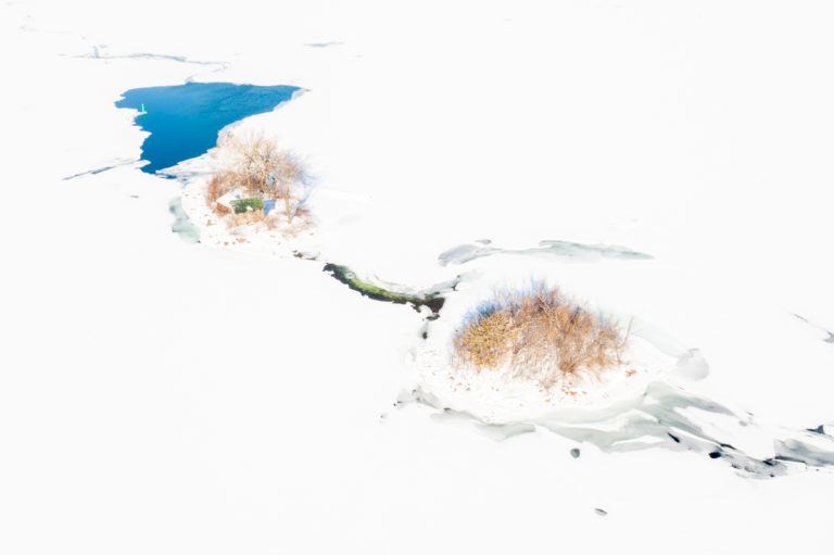 Frozen River Islands Surrounded by Cracked Ice