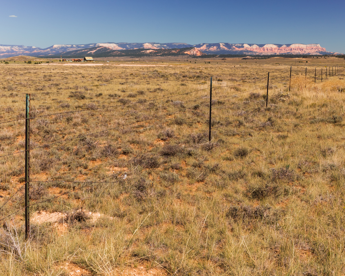 Fenceline and Snow-Capped Plateau