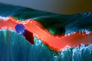 Teal Sheet Peeling From Orange Plane